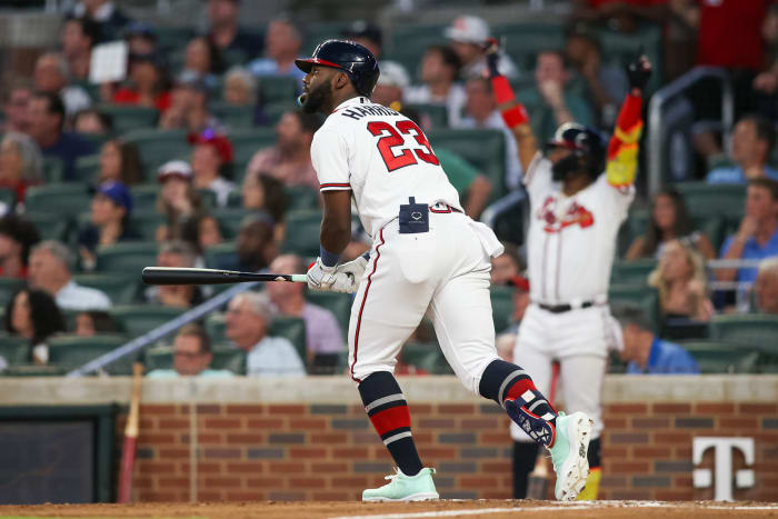Aug 1, 2023; Atlanta, Georgia, USA; Atlanta Braves center fielder Michael Harris II (23) hits a home run as right fielder Ronald Acuna Jr. (13) looks on against the Los Angeles Angels in the fifth inning at Truist Park.